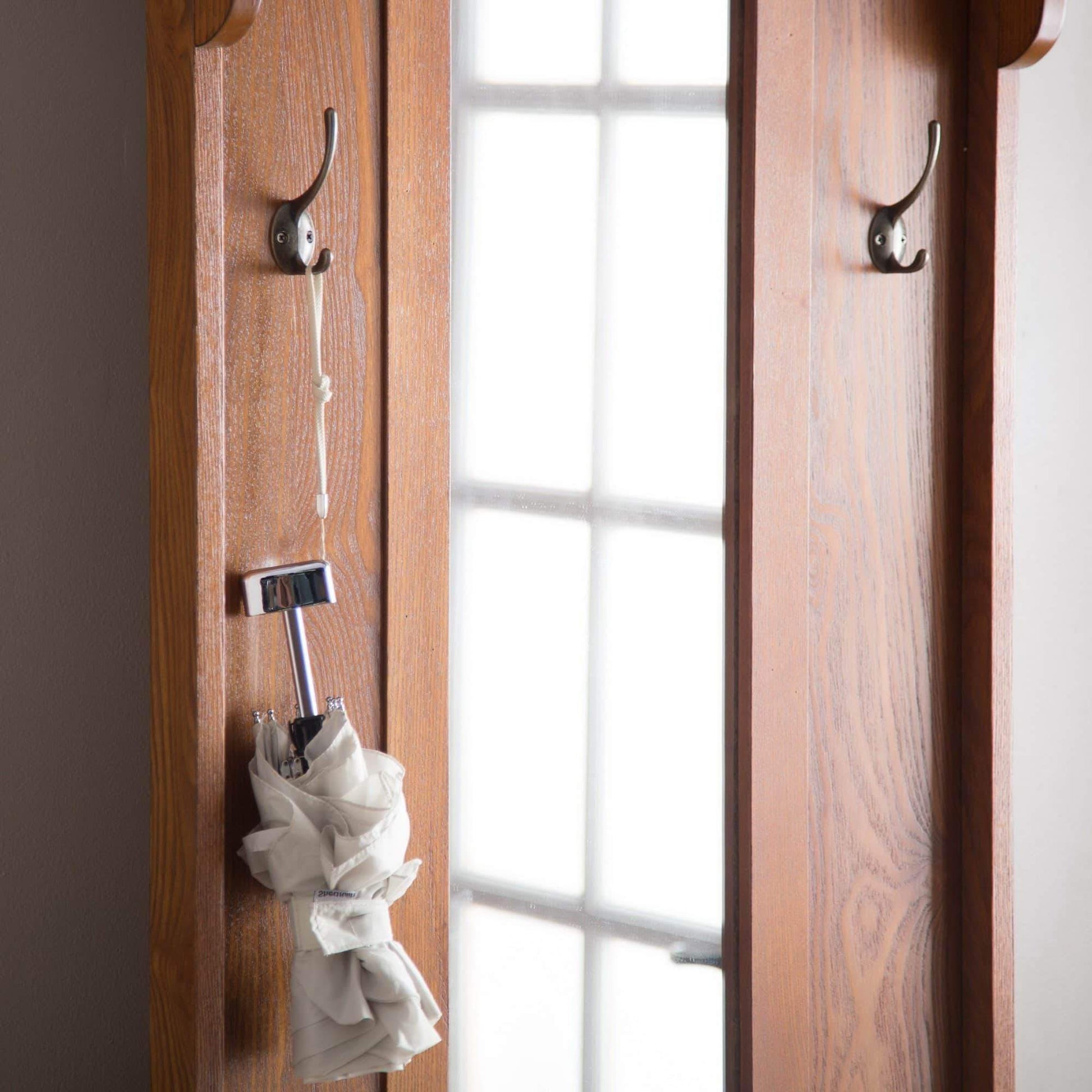 Best wooden entryway tall hall tree bench coat and hat rack with mirror in oak finish with 2 double hooks in antique bronze storage bench base and a full length central mirror